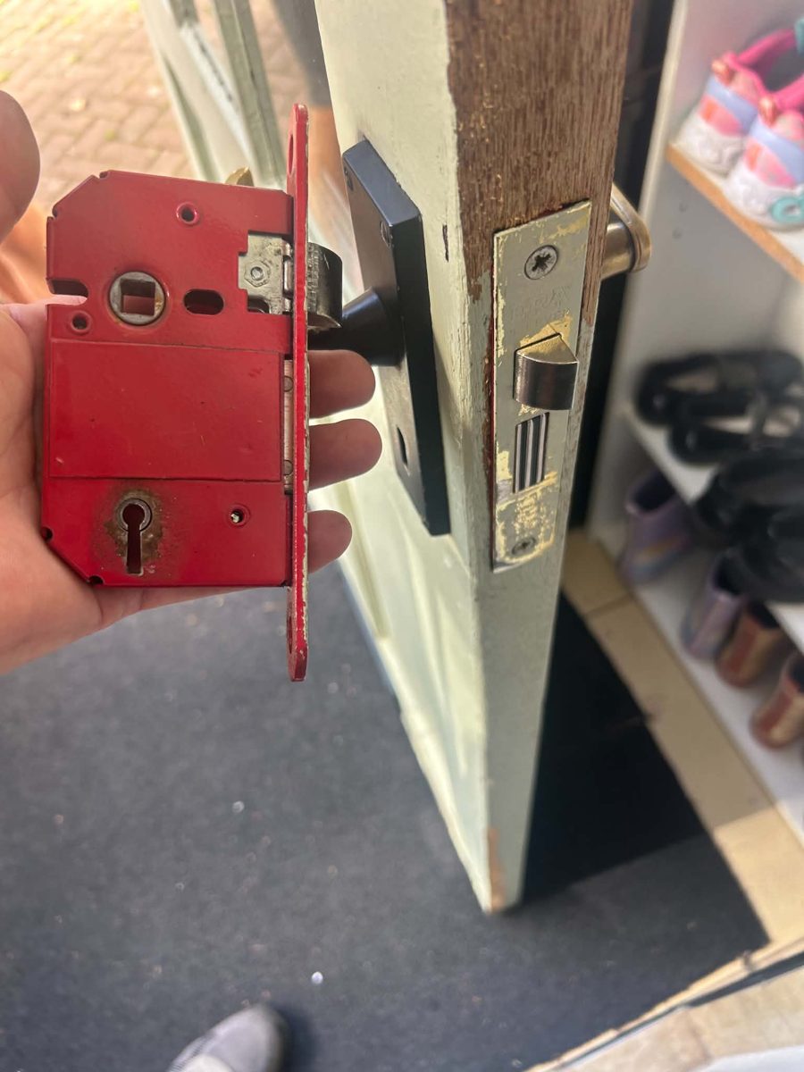 Old red mortice sashlock removed from a wooden front door